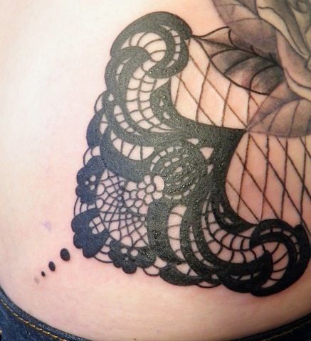 The black ink of this lace tattoo adds to the seductive appeal of the design, bringing to mind lingerie