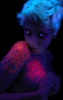 Trippy UV tattoo designs of flowers. The tattoo uses invisible ink that will glow under black light