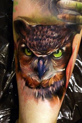 A beautiful, artistic tattoo of an owl in an oil painting style