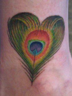 A clever tattoo artist has given this peacock feather tattoo design a heart shape