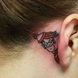 A cute and clever placement of a Wheres Waldo tattoo, behind the ear