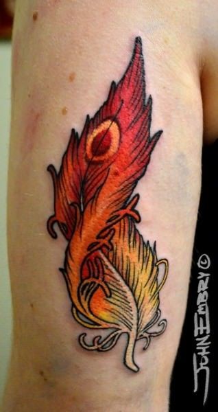 A fiery red and orange phoenix feather tattoo that includes an eye, symbolic of being watched over by a higher power