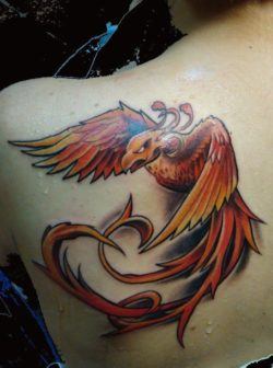 A powerful tattoo design of a phoenix bird in an agressive flying pose