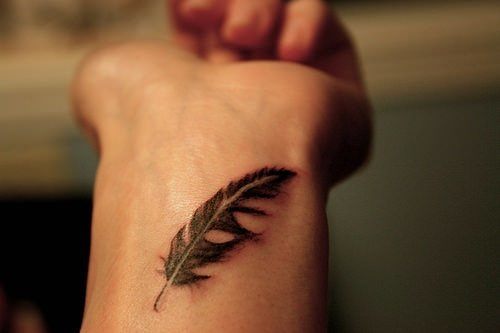 A simple feather tattoo on the wrist is a constant reminder of spiritual ambitions