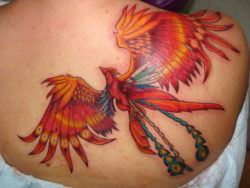 This creative phoenix tattoo uses blue feathers to accentuate the fire bird's red and gold plumage