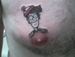 This funny tattoo has Waldo perched behind the nipple the way that he is on the cover of the Waldo puzzle books