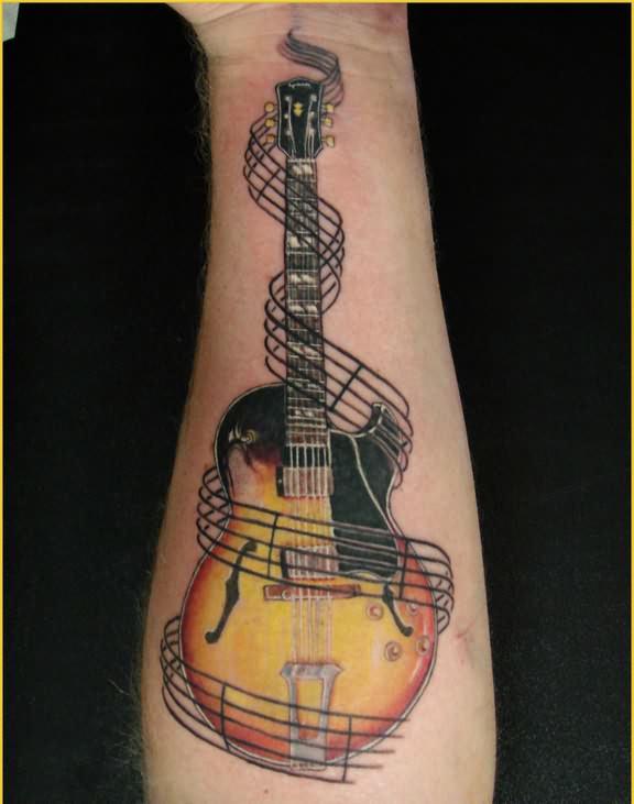 A high quality music tattoo of a guitar surrounded by musical staves