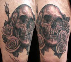 A skull sits among roses in this Shawn Barber tattoo design.