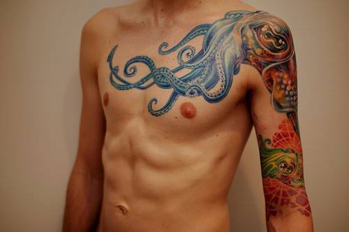 A tattoo of two squids in a science fiction art style decorates this guys arm and shoulder