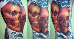 This knee tattoo of two human skulls shows off the high quality of Shawn Barbers tattoos