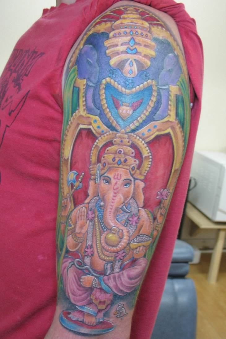 In this tattoo design Ganesh is depicted as having pink skin tones. Other popular colors are blue and green.