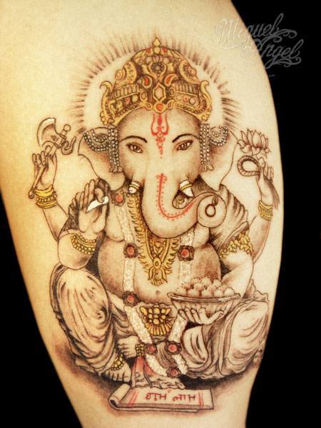 In this tattoo design, Ganesh sits in the lotus position and holds a lotus flower in his upper left hand