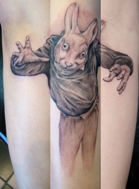 A crazy zombie rabbit creature reaches out of this unusual rabbit tattoo design