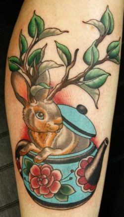 A wolpertinger bunny rabbit with tree branch horns peeks out of a teapot in this old school tattoo design