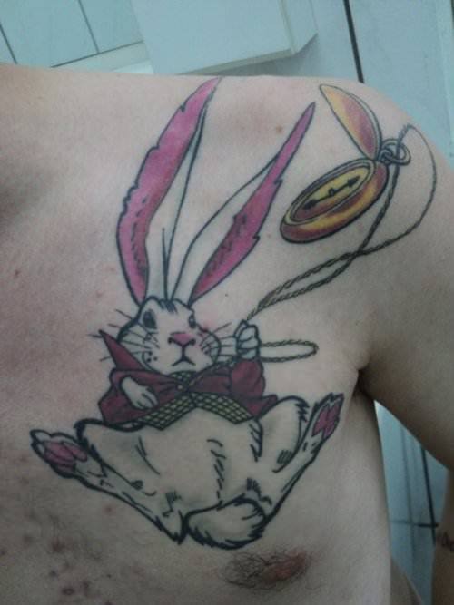 A tattoo of the White Rabbit from Alice in Wonderland falling down the rabbit hole