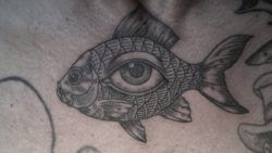 A human eye lives in the side of a fish in this illustrative tattoo by Otto D Ambra