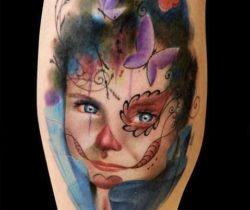 A photo realistic and artistic tattoo of a little girl wearing sugar skull face paint by Alex de Pase