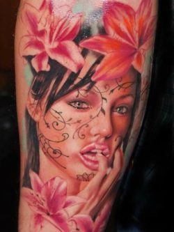 A sexy girl poses with flowers in this fantastic tattoo by Alex de Pase
