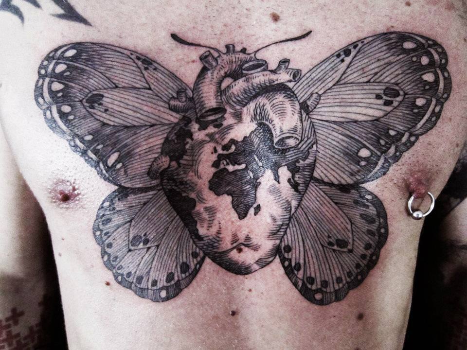 An Otto D Ambra tattoo that combines a human heart, planet earth and a butterfly