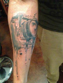 An illustration of a camera melts in this tattoo design by Pietro Romano