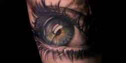 Niki Norberg combines greyscale and color areas to add appeal to this realistic eye tattoo