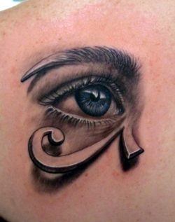 This artistic tattoo combines a realistic eye and graphic of the Eye of Horus patterns