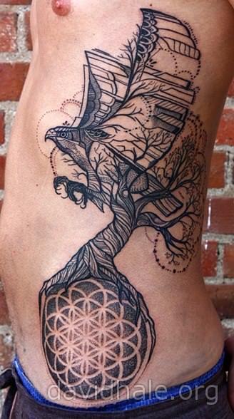 An eagle, tree of life and a mandala flower appear in this illustrated tattoo by David Hale