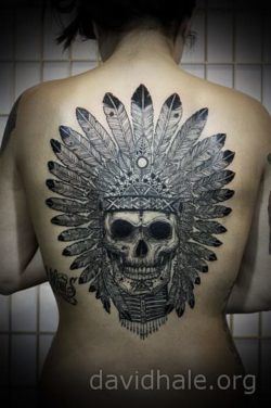 The skull of a Native American witch doctor is the focus of this illustrated tattoo by David Hale