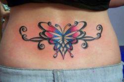 This beautiful lower back tattoo of a butterfly uses a feminine, floral style