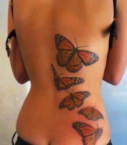 This feminine tattoo uses natural looking butterlies to create an organic effect