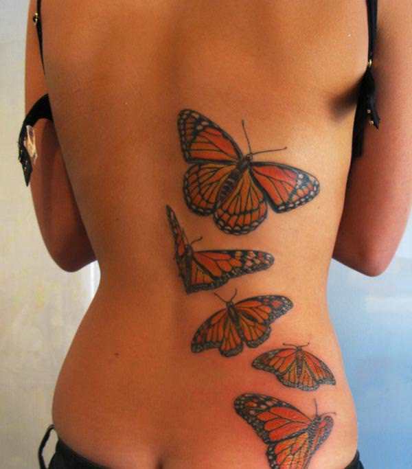 This feminine tattoo uses natural looking butterflies to create an organic effect