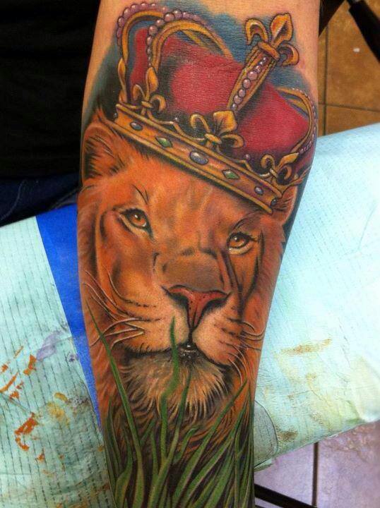 This lion tattoo adds to the royal meaning of lions by including a jeweled crown in the design
