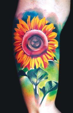 A bright and colorful tattoo of a cheerful sunflower by Ivana Belakova