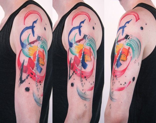 A colorful and fun abstract tattoo by Amanda Wachob that mimcs the original brushtrokes of the painted design