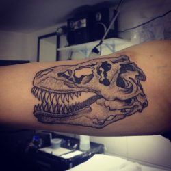 A dot work tattoo of a dinosaur skull by Gregorio Marangoni