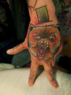 A fearsomely comic bear is the subject for this colorful abstract watercolor tattoo by Sven Groenewald