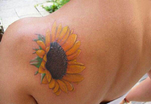 A summery tattoo design of a sunflower on sun kissed skin is a perfect symbol of joy and fun