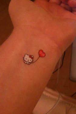 A tiny Hello Kitty tattoo on the wris looks almost like a sticker