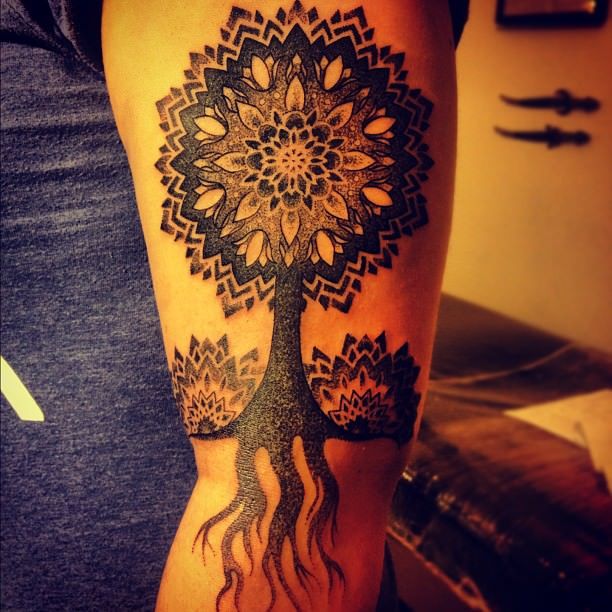 Gregorio Marangoni uses mandala flowers and thousands of dots to create this tree of life tattoo design