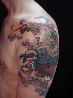 Tattoo by Hide Ichibay of a baboon in a Japanese illustration style