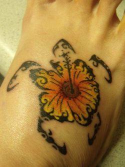 This creative tribal tattoo uses a sunflower as the shell of a sea turtle