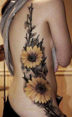 This stylish sunflower tattoo uses subdued colors but still apears fun and friendly