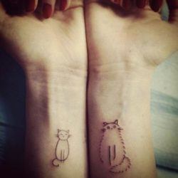 Two cute, simple drawings of cats become fun wrist tattoos