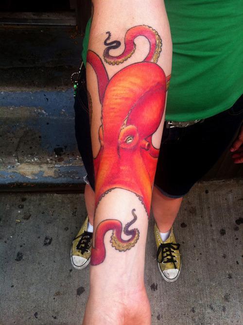 Bold red colors give this mean looking octopus tattoo an extra edge