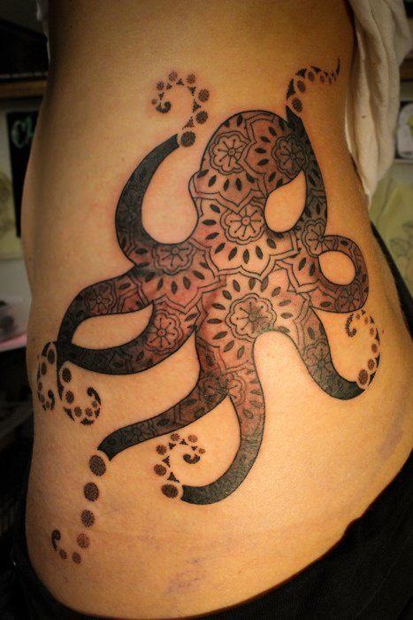 This abstract octopus tattoo design boasts paisley patterns and decorative dots