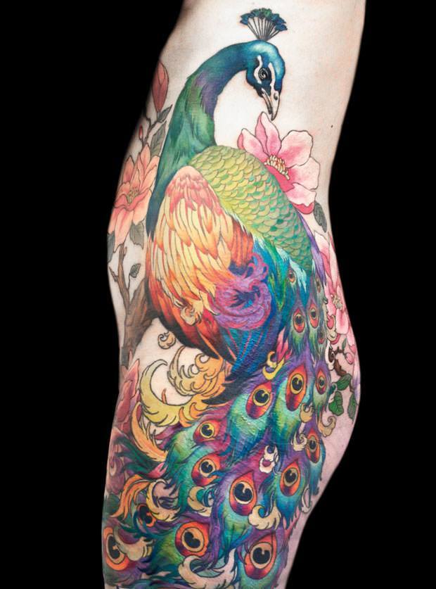 This amazing peacock tattoo across the hip and leg can be hidden under clothing and revealed only to an intimate loved one