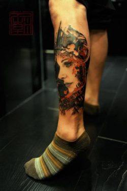 This gorgeous portrait tattoo of a beautiful girl with abstract designs is from the Tattoo Temple in Hong Kong