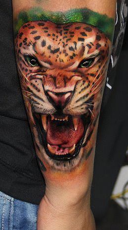 Carlox Angarita combines his own artistic style with photo realism to create this snarling leopard tattoo