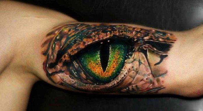 Highly detailed and photo realistic, this lizard eye tattoo by Carlox Angarita is unusual and appealing