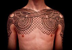 Using brown tattoo ink and a dotwork technique, Peter Madsen has created an ornamental chest tattoo design